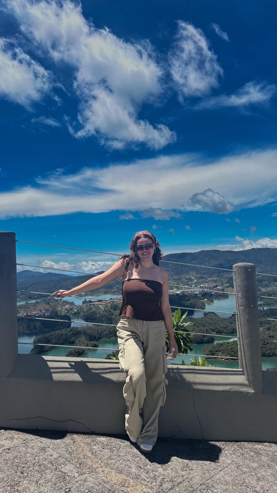 Bárbara, travel planner de Flymingo, en un mirador de Guatapé, con los embalses y las islas verdes de fondo.